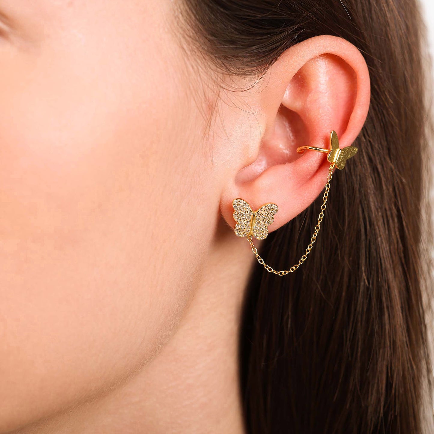 Female Model Wearing Gold Butterfly Stud with Chain Ear Cuff Sia - Playa Luna Jewelry