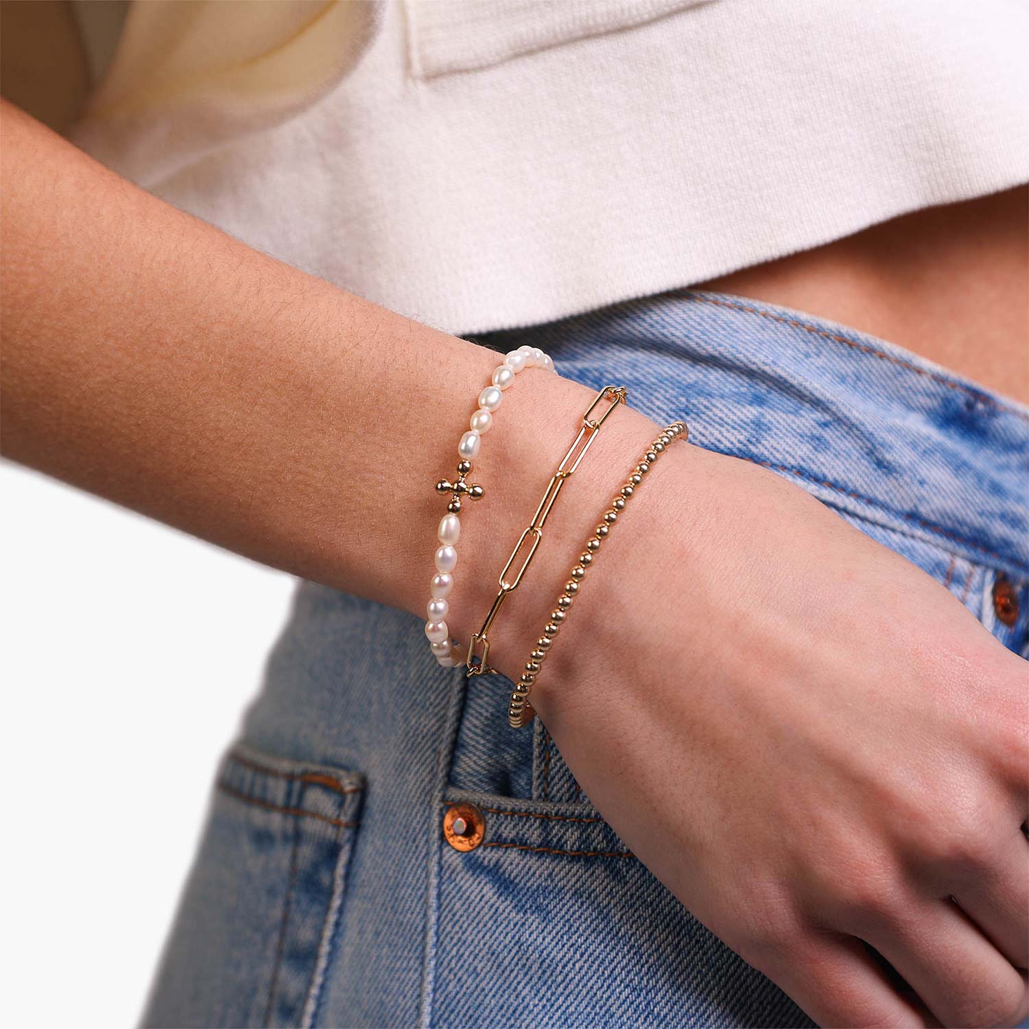 Female Model Wearing Layered Gold Flower Pearl Bracelet Nicole - Playa Luna Jewelry