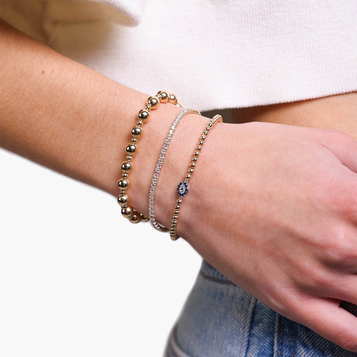 Female Model Wearing Layered Small Gold Filled Evil Eye Bead Bracelet Jenna - Playa Luna Jewelry