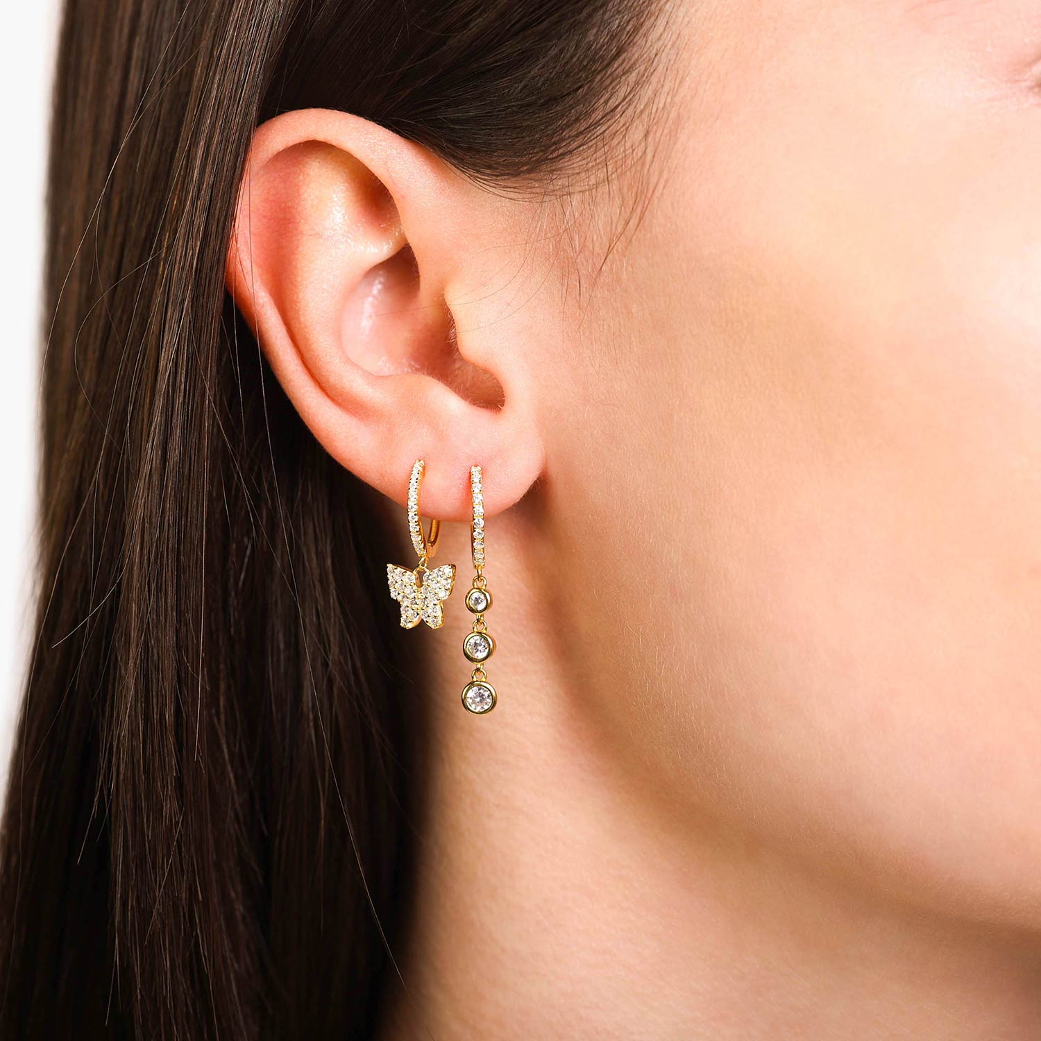 Female Model Wearing Gold Butterfly Huggie Hoop Earrings Alexa layered - Playa Luna Jewelry