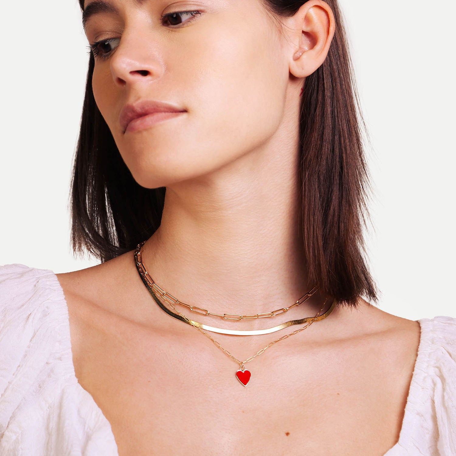 Female Model Wearing Layered Red and Gold Heart Necklace Anna - Playa Luna Jewelry
