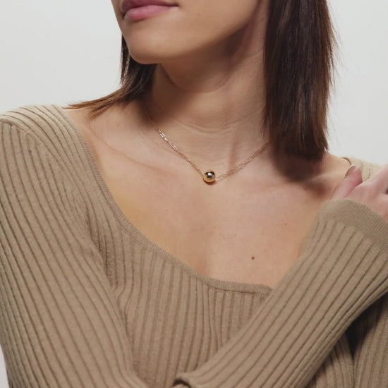 Female Model Showing Gold Pendant Ball Necklace Aria - Playa Luna Jewelry